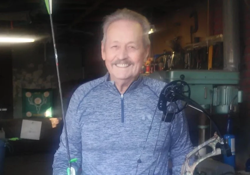 a person smiling with a microphone