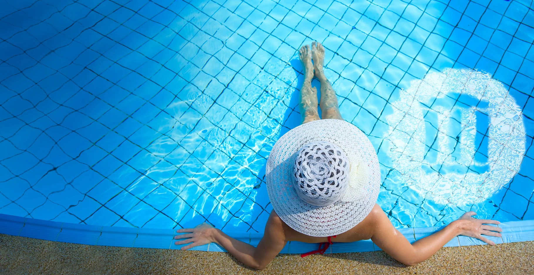 a woman wearing a hat and holding her hands up in the air