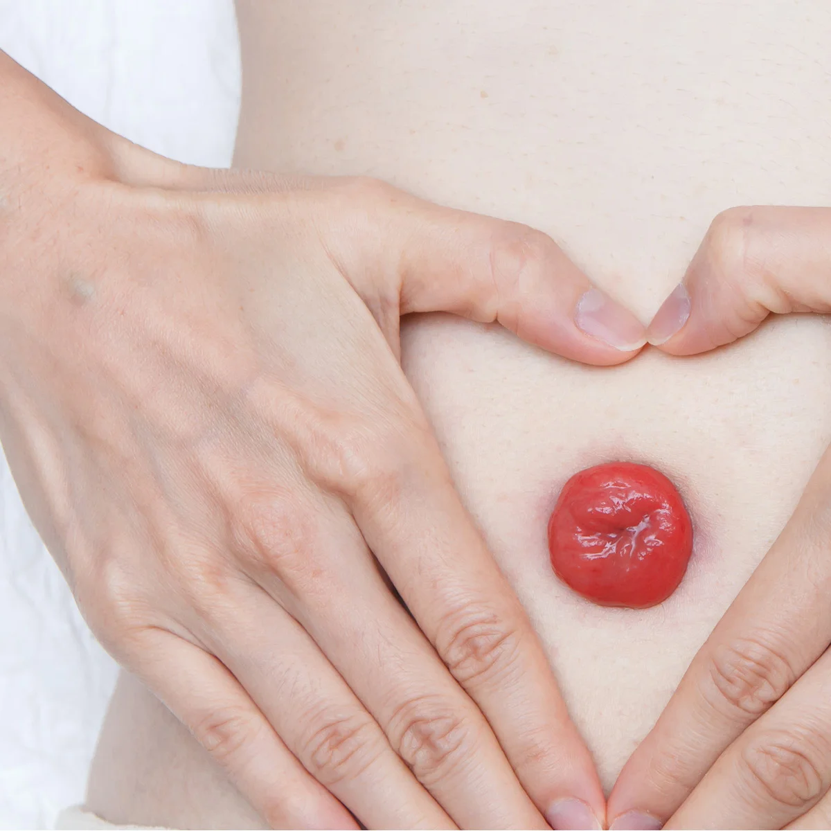a hand holding a red heart