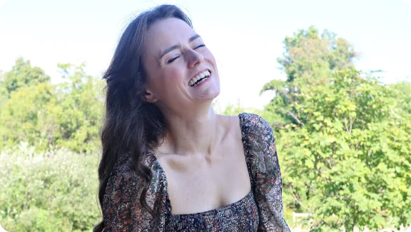 a woman smiling outside