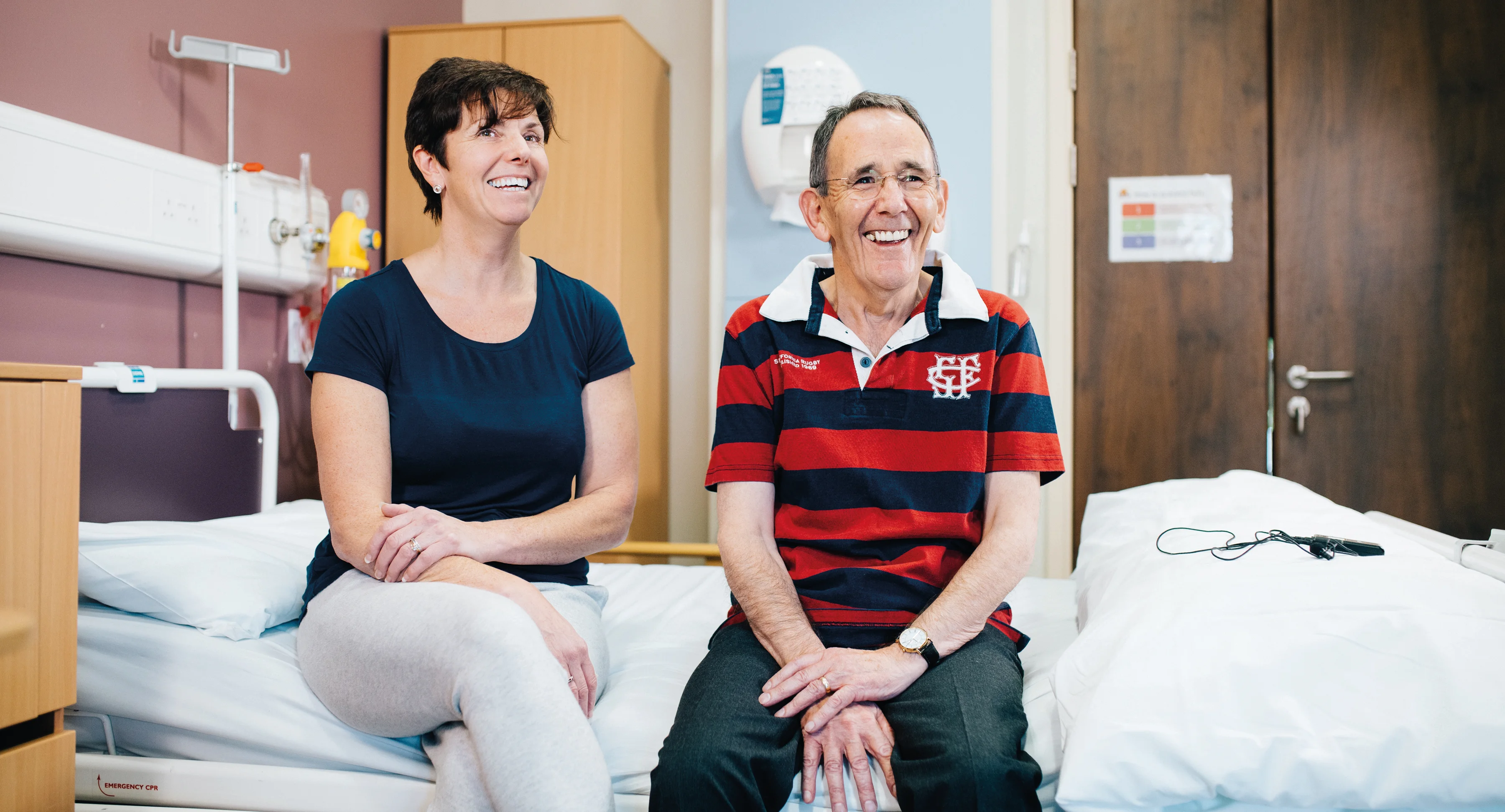 a man and woman sitting on beds